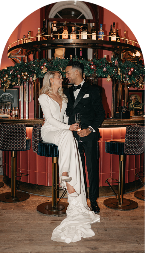 Newlyweds Sophie and Brett sitting in The Salon Bar, after their wedding ceremony at Kindred